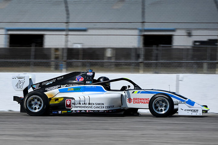 Race car with Simon Cancer Center advertised on it.